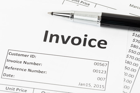 Invoice with pen; document is mock-upの写真素材
