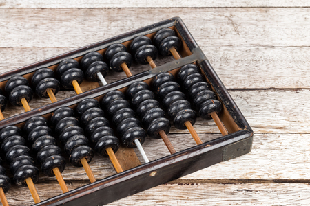 Old abacus on wooden backgroundの写真素材
