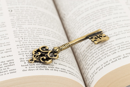 Vintage key on holy bible page concept theology studyの写真素材