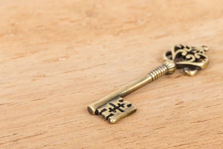 Antique key on wooden backgroundの写真素材