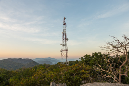 Communication tower antenna on mountain at twilight