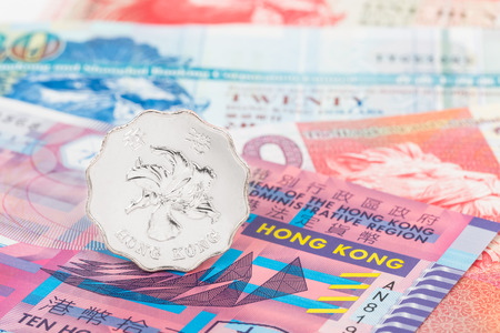 Hong Kong dollar coin stand on banknote moneyの写真素材