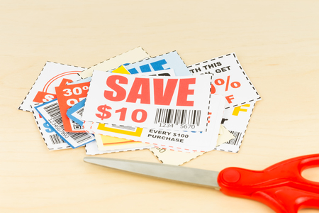 Saving discount coupon voucher with scissors, coupons are mock-upの写真素材
