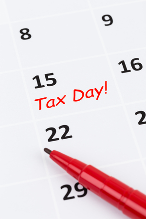 Tax day on calendar with red marker penの写真素材