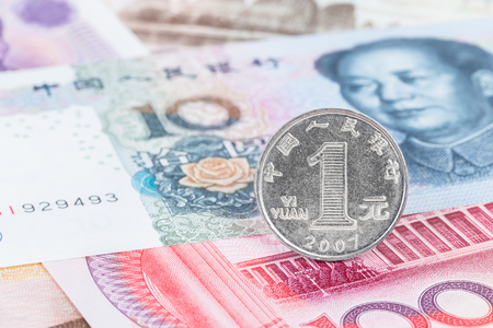 Chinese coin yuan stand on China banknote moneyの写真素材