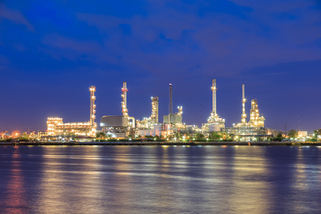 Oil refinery on water front at twilightの写真素材