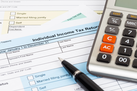 Tax form with pen and calculator; document are mock-upの写真素材