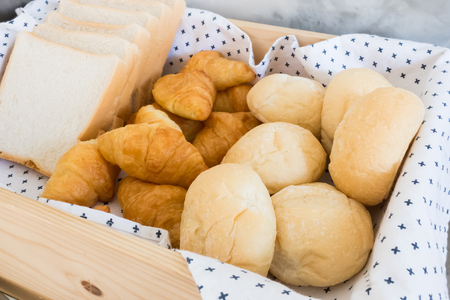 Bread in wooden basket breakfastの写真素材