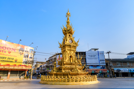 Chiang Rai, Thailand - February 19, 2018: Golden clock tower at city center. Designed by Master Chalermchai Kositpipat, National artist.のeditorial素材