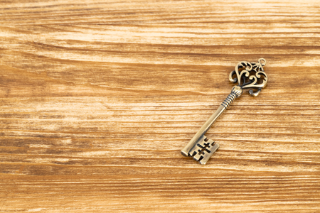 Vintage key on wooden backgroundの写真素材