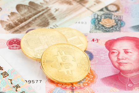 Bitcoin token on Chinese yuan banknote moneyの写真素材