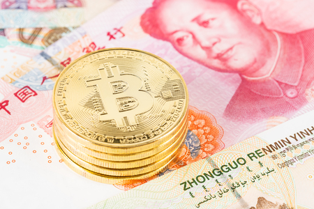 Bitcoin token on Chinese yuan banknote moneyの写真素材