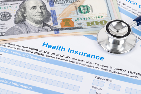 Health insurance application form with stethoscope and calculatorの写真素材