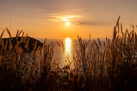 Beautiful sunset on Andaman sea at Windmill View Point near Laem Promthep Cape, Phuket, Thailandの写真素材