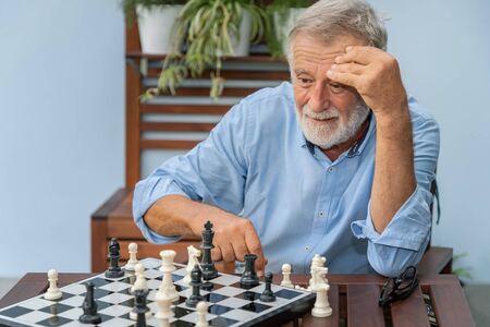 Elderly playing chess in nursing home for leisureの写真素材