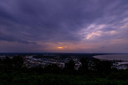 Pak Nam Chumphon town, fisherman village, and river from Khao Matsee scenic viewpoint during twilightの写真素材