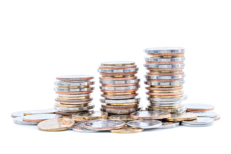 Stack of coins on white background; business, finance, and investment concept