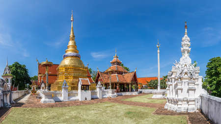 Golden pagoda and Buddha pavilion at Wat Pong Sanuk temple in Lampang, north of Thailand, panoramaの写真素材