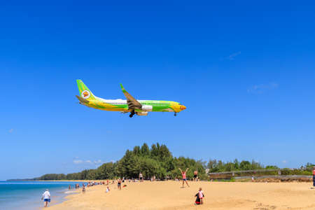 Phuket, Thailand â€“ February 12, 2020: Passenger airplane landing to airport above Mai Khao...
