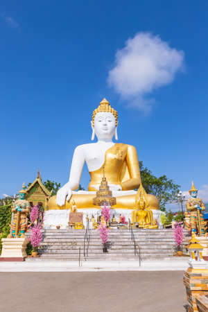 Chiang Mai, Thailand - November 19, 2018: Outdoor big sitting Buddha statue at Wat Phra That Doi Kham Temple, one of famous monastery in province.のeditorial素材