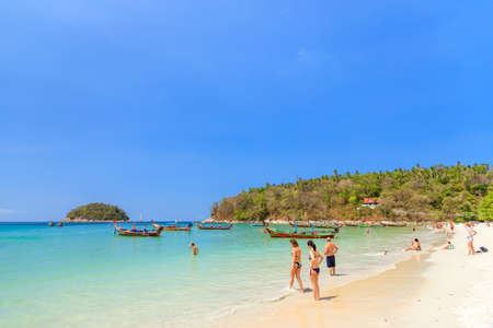 Phuket, Thailand â February 14, 2020: Tourist and crystal clear turquoise blue sea at Kata Beach, famous travel destination in province.のeditorial素材