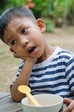 Asian Child is Waiting to Eat the Breakfast Outdoor.
