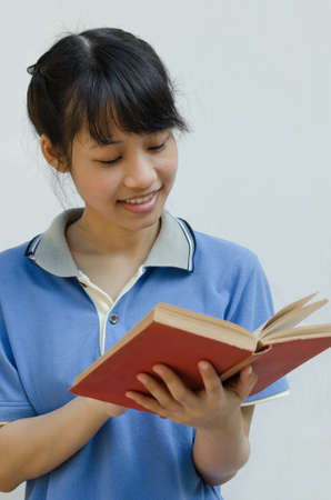Asian Teenager Girl Enjoy Reading a Book.の写真素材