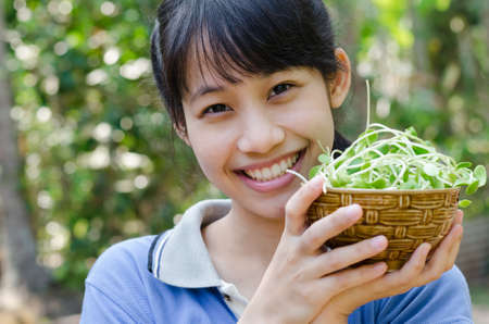 Asian Teenager Girl Happy with the Vegetable (Sunflower Sprouts).の写真素材