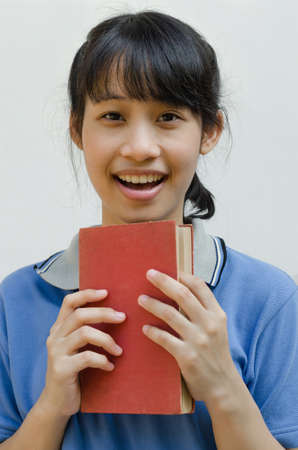 Asian Teenager Girl Happy After Reading a Book.の写真素材
