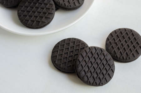Stuffed Dark Chocolate Cookies in Ceramic Plate on White Background.の写真素材