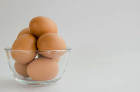 Eggs in Glass Bowl on White Background.の写真素材