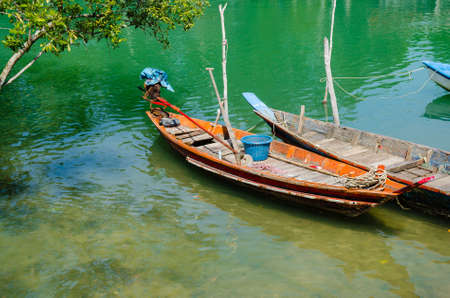 Wood Boats Moored on the Riverbank of Clear River.の写真素材