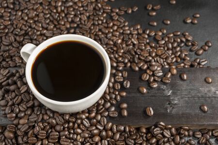 White coffee cups and beans on the old table The top view has space for your messages.の写真素材