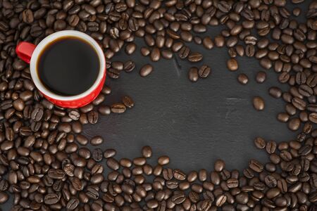Red coffee cups and beans on the table The top view has space for your messages.の写真素材