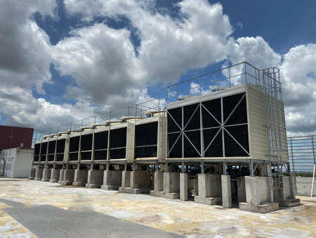 Cooling tower machinery in large buildings That is clear sky With white clouds scattering the sky