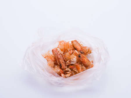 Shrimp food scraps in plastic bags on white backgroundの写真素材