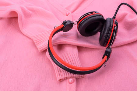 Beautiful pink knit sweater texture And headphones red - background pictureの写真素材