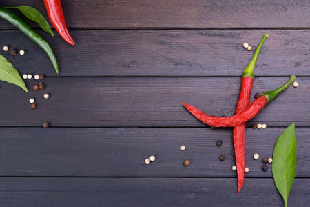 Red chili and peppers on a dark vintage wooden table top viewの写真素材