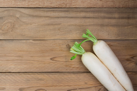 white radish on rustic wooden table with copy space - top viewの写真素材
