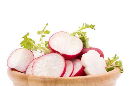 Close-up shot of bright red radishes from the garden and sliced â€‹â€‹radishes in a wooden...