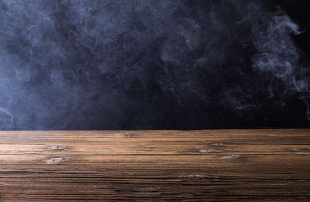 Wooden floor or table with white fog or smoke. on a black background