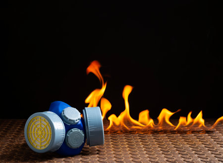 Respirator or gas mask in smoke on a black background. Prevent poisoning, dust, and affected area...