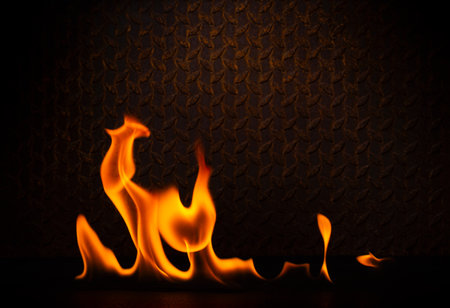fuel flame png heat and danger of burning bbq explosion yellow-red flame isolated on rusty black steel plate backgroundの写真素材