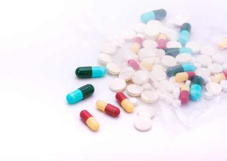 Colorful pills with capsules and pills in zip-lock plastic bags. isolated on white backgroundの写真素材