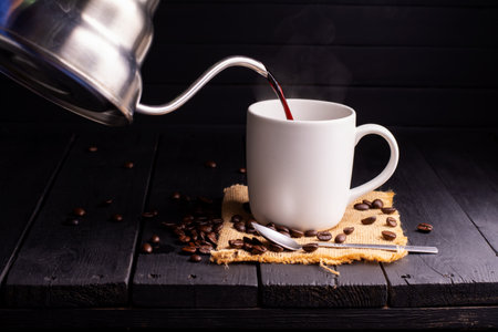 Fresh coffee Pour the coffee into the cup. or coffee mug on the wooden table espresso mocha cappuccino baristaの写真素材