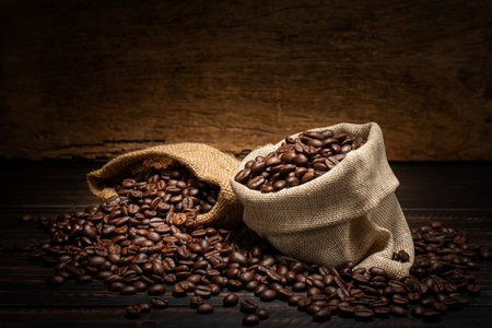 coffee beans in sacks on wooden backgroundの写真素材