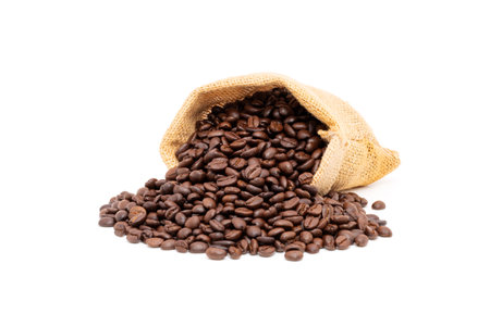 Heap of brown roasted coffee beans in burlap bags isolated on white background. fresh coffee beans conceptの写真素材