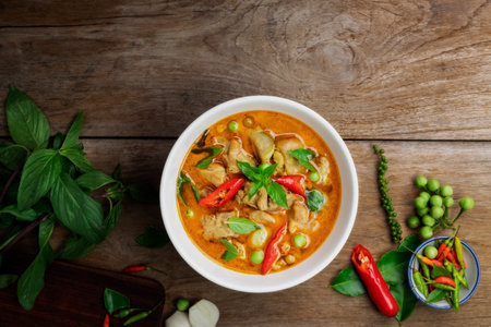 Chicken green curry Asian food, Beef green curry Thai food on a soup bowl with a mixture of herbs, vegetables and Thai red chilli spices. Top view.の写真素材
