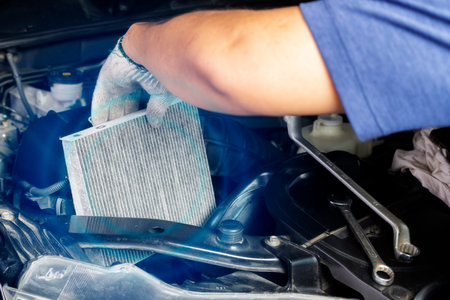 Car air conditioner system maintenance, Hand mechanic holding car air filter to check for clean dirty or fix repair heat have a problem or replace new or change filter.の写真素材