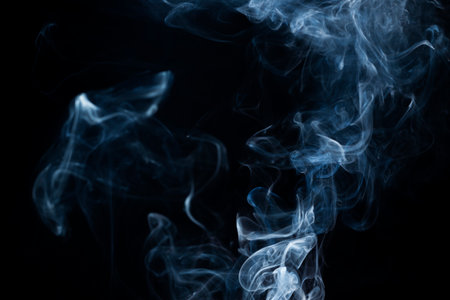 Smoke from flames or fog clouds graphic design art isolated on dark black background.の写真素材